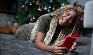 woman holding red smartphone